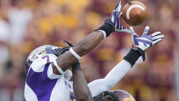 Sep 14, 2013; Minneapolis, MN, USA; Western Illinois Leathernecks wide receiver Lance Lenior Jr. (17) catches a pass over Minnesota Golden Gophers defensive back Brock Vereen (21) in the fourth quarter at TCF Bank Stadium. The Gophers won 29-12. Mandatory Credit: Jesse Johnson-USA TODAY Sports  